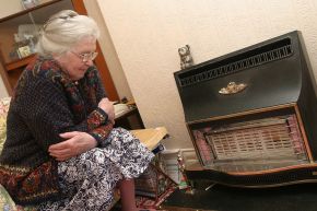 Older lady shivering by aniquated gas fire